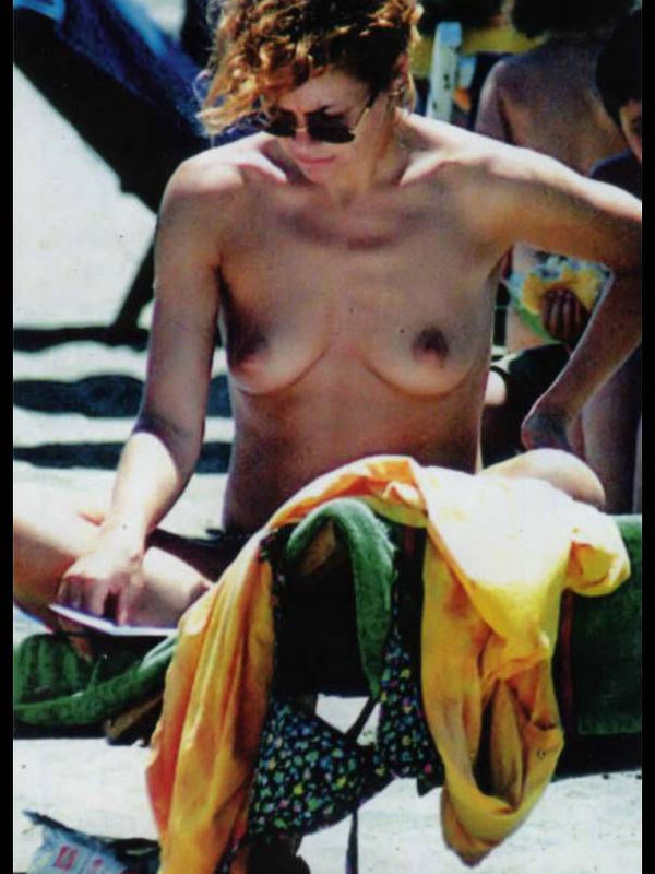 Italian actress Elena Sofia Ricci topless on a beach paparazzi photos.
