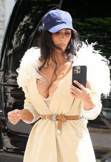 Kim Kardashian steps out in plunging feathered look topped with a baseball cap in Paris - May 15, 2025