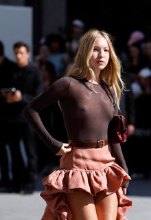 Lila Moss braless in see through top and mini skirt at Saint Laurent Menswear Spring/Summer 2026 Show Photocall at Paris Fashion Week - June 24, 2025