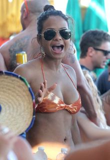 Christina Milian showing off her bikini body while out partying on the beach in Cabo San Lucas - March 16, 2013