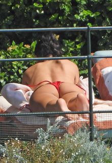 Dua Lipa in red bikini sunbathes poolside in Portofino, Italy - August 15, 2026